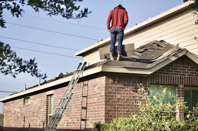 Professional roofer working on a residential roof in Manteca